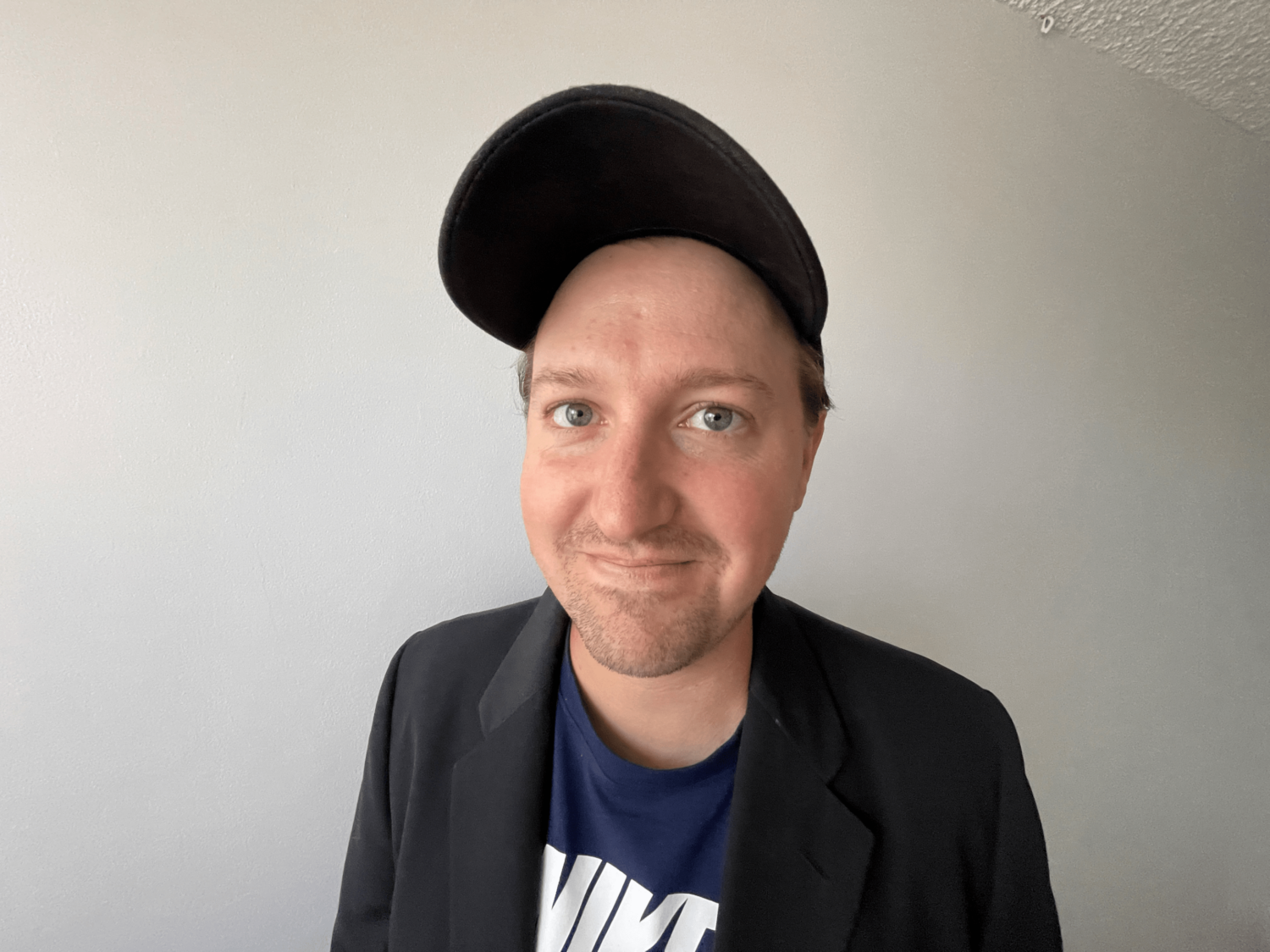 Example showing a portrait of a man wearing a cap taken close up with a wide angle iPhone lens.