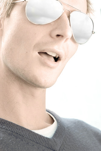 Headshot photo of Zach Douglas with sunglasses photographed with the high key lighting look.