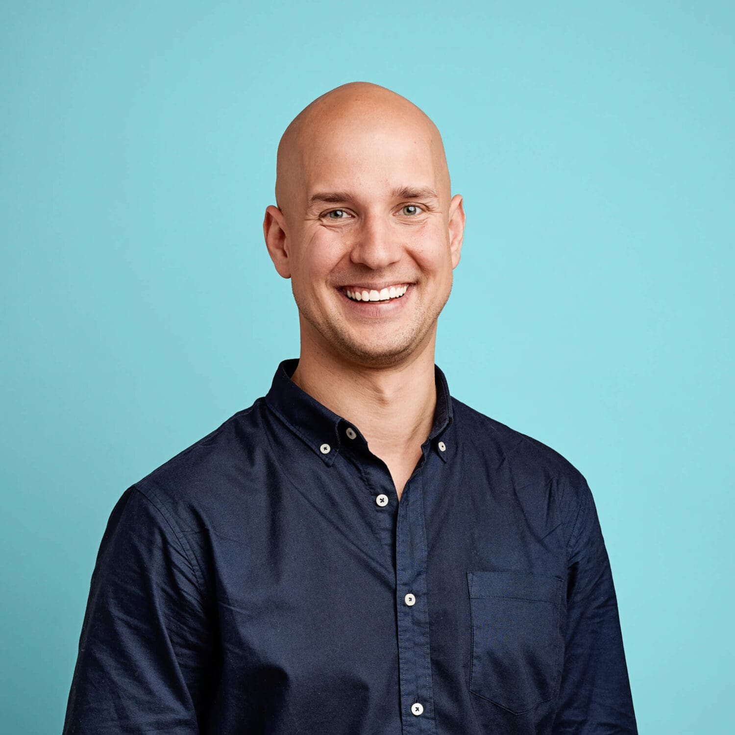 Example of a headshot of a bald man with even lighting and good preparation.